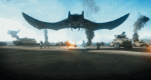 a group of people standing in front of a large flying object in the sky