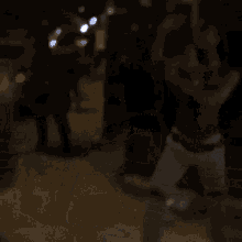 a blurry picture of a group of people dancing on a blue background