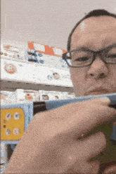 a man wearing glasses is looking at a phone