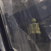 a man wearing a hard hat and a safety vest that says maintenance on it