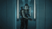 a woman standing in a hallway with a man standing behind her
