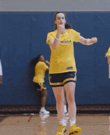 a girl wearing a yellow shirt that says indiana