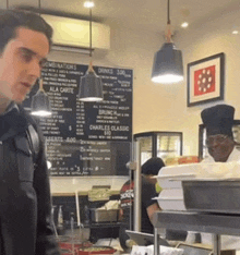 a man is standing in front of a menu that says combinations