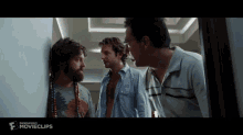three men are standing next to each other in a room with the word movieclips on the bottom of the screen
