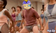 a group of people are dancing with a man wearing a mask with a monkey on it
