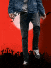 a man walking in a cemetery with a red background