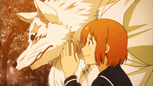a girl petting a white wolf 's face with her hands