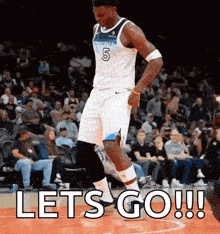 a basketball player is dancing on the court with the words let 's go written below him .