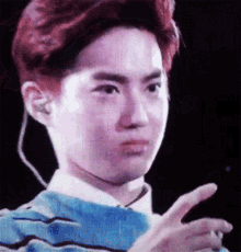 a young man with red hair is making a funny face and pointing