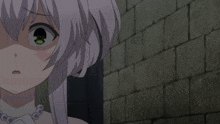 a close up of a girl 's face with a brick wall behind her
