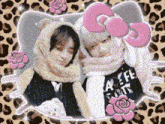 two people wearing hello kitty hats and scarves are posing for a picture