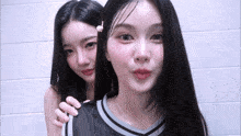 two young women are standing next to each other and making funny faces