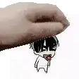 a hand is holding a cartoon character on top of a white background .