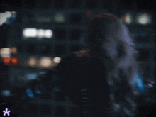 a blurry picture of a person with a purple star in the corner
