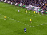 soccer players on a field with a banner that says unibet on it