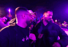 a man wearing glasses and a jacket that says la on it