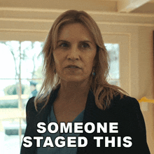 a woman is standing in front of a window with the words someone staged this behind her