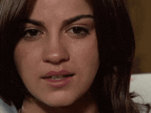 a close up of a woman 's face with a tear running down her face