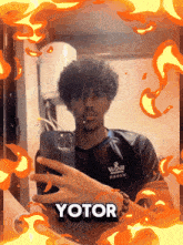 a man taking a picture of himself with yotor written in the corner