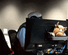 a man sitting in front of an asus computer monitor