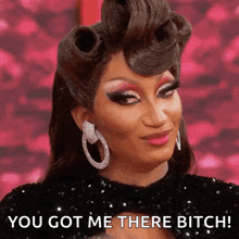a drag queen is making a funny face and says you got me there bitch .