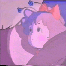 a girl with a red bow on her head is looking at a cat