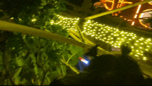 a blurred image of a ferris wheel at night with a few lights on it