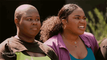 two women are standing next to each other and one is wearing a purple jacket that says prime video