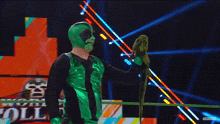 a man in a green mask holds a green parrot in his hand