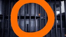 a large orange circle is surrounded by a prison cell