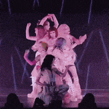 a group of women are dancing on a stage