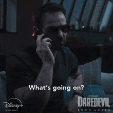 a man talking on a cell phone with the words what 's going on