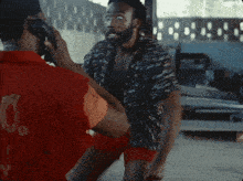 a man in a red shirt with the number 16 on it