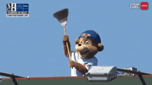 a cubs mascot holds a broom in front of a sign that says nation