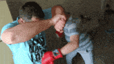 a man wearing a shirt that says ' dirty boys ' on it is boxing another man