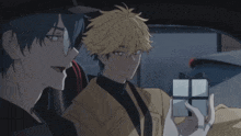 two anime characters are sitting in a car one is holding a gift box