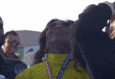 a woman is wearing a lanyard that says new shepard
