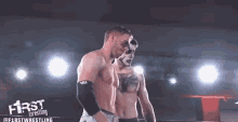 two men are wrestling in a ring and one has a face painted like a skeleton .