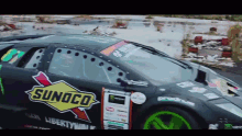 a black race car with a sunoco logo on the side