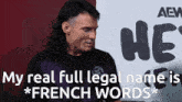 a man with a mullet is standing in front of a sign that says he