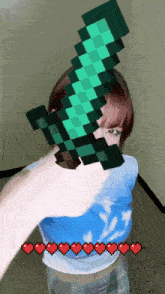 a girl is holding a minecraft diamond sword in her hand
