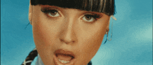 a close up of a woman 's face against a blue background