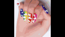 a close up of a woman 's nails with a rainbow design on them