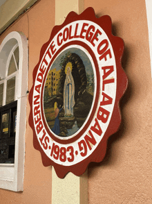 a red and white sign that says college of albabang