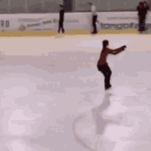 a person is ice skating on a rink with a sign that says bistro on it