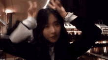 a woman is making a peace sign with her hands