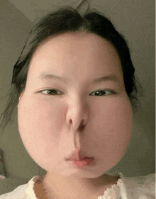 a close up of a woman 's face with a big nose