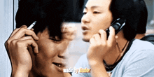 a man smoking a cigarette next to another man talking on a cell phone with the words made by tito on the bottom