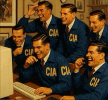 a group of men wearing blue jackets that say cia are laughing at a computer
