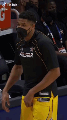 a man wearing a mask and a shirt that says all star on it
